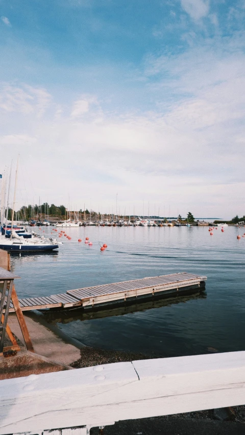 the dock is at an empty marina, near some boats