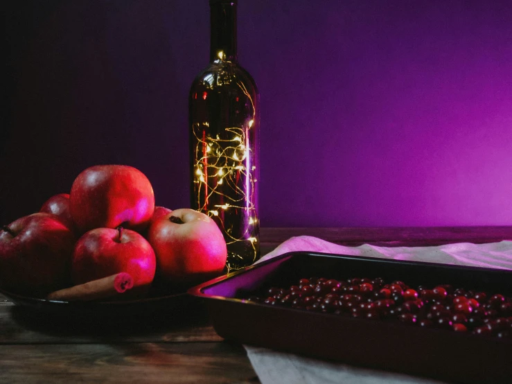 a bottle of wine sitting next to some fruit