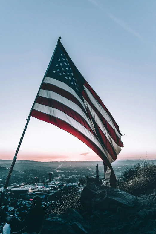 a flag on top of a mountain, against the sky