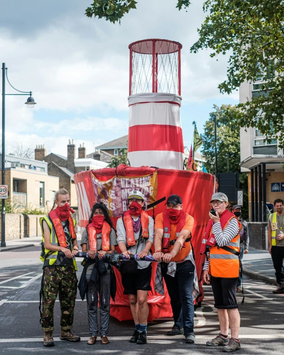 a group of people standing around a man dressed as an orange raft