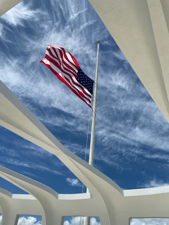 an american flag flying at the top of a memorial