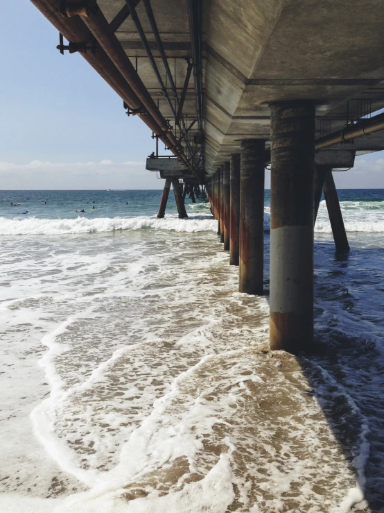 a view from underneath a pier that is partly submerged