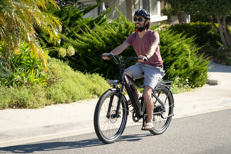 a man riding a bike on a street next to a street