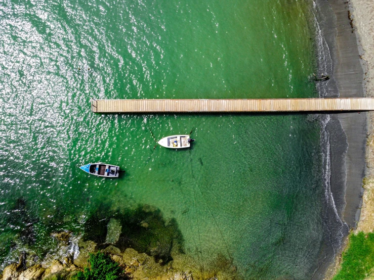 two boats in the water by a bridge