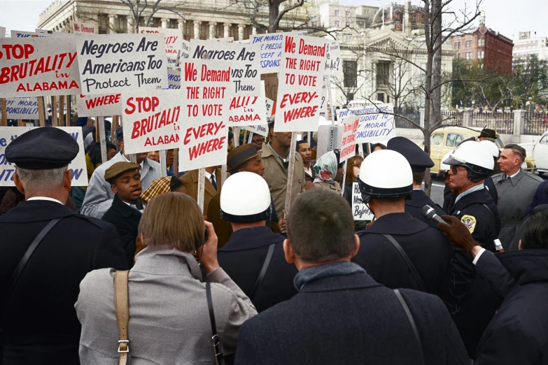 there are many protesters holding up protest signs