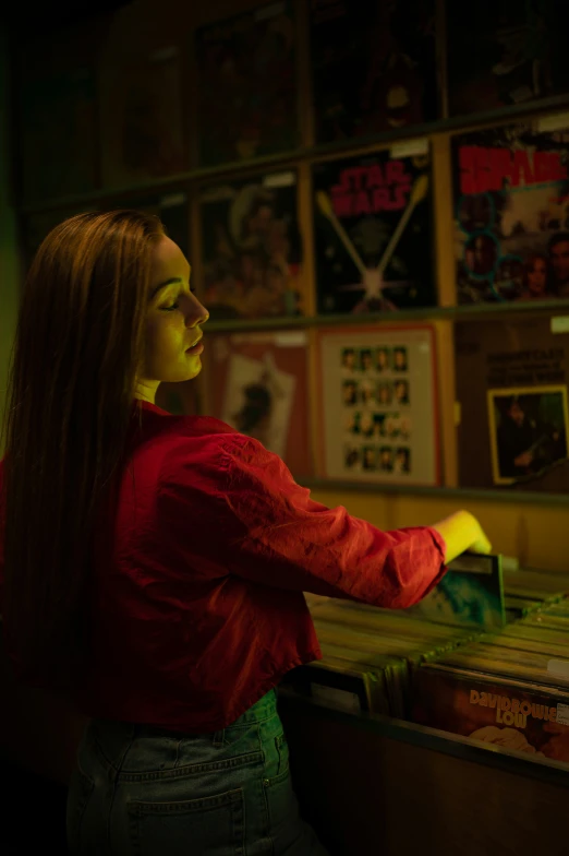 a woman in a red shirt is holding a bar