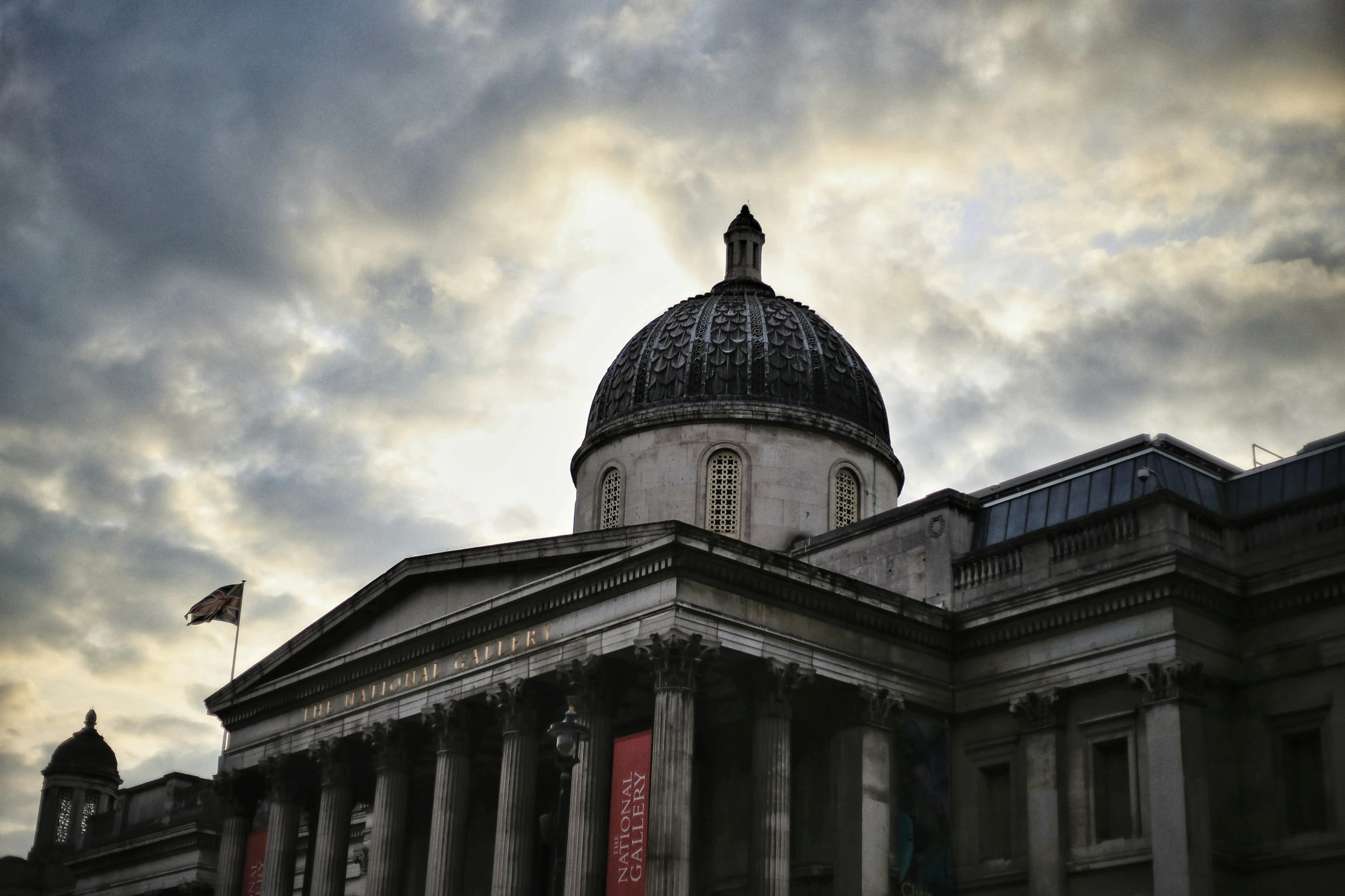 an ornate building with a dome and two tall pillars on it