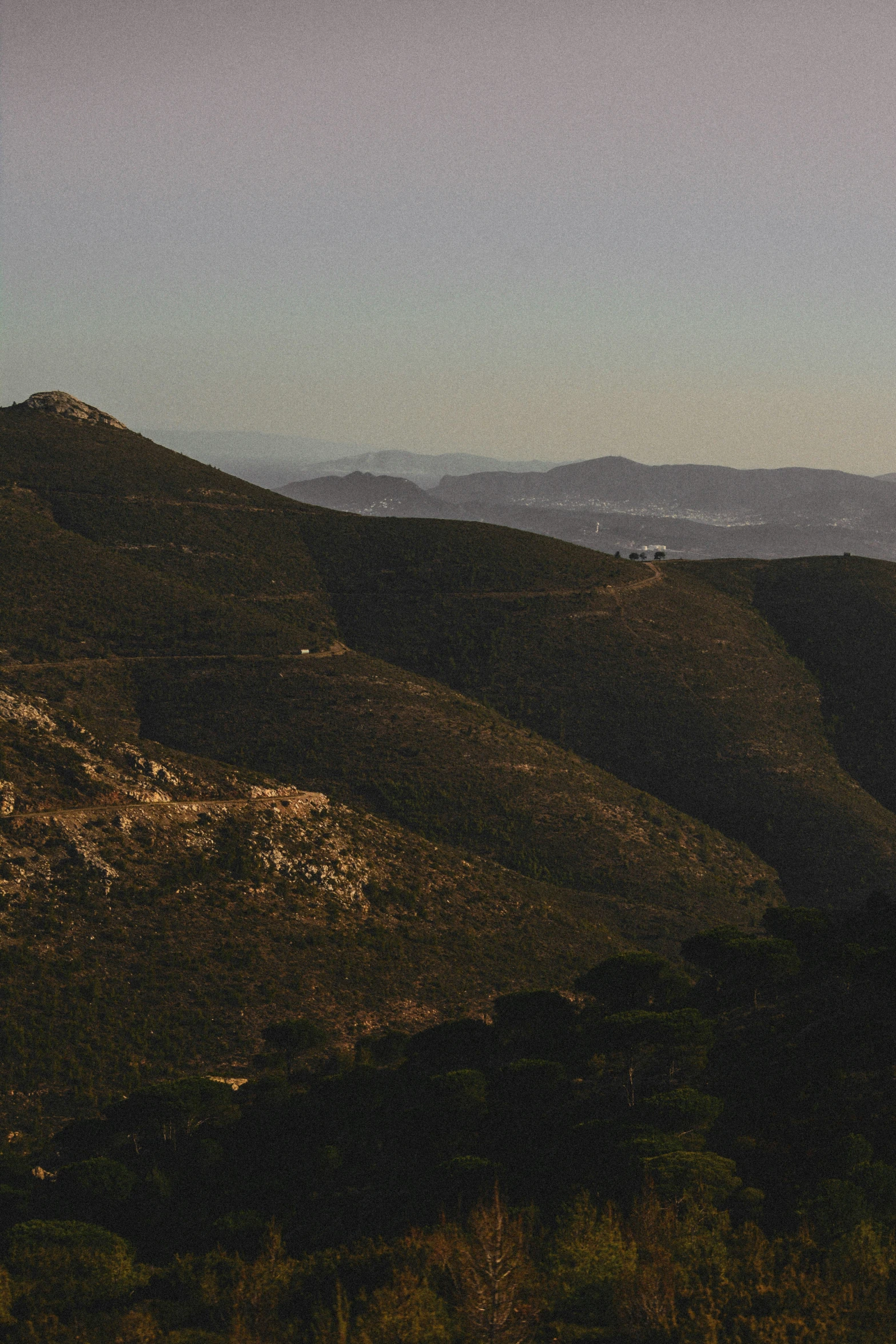 the view from above of mountains looking down at trees