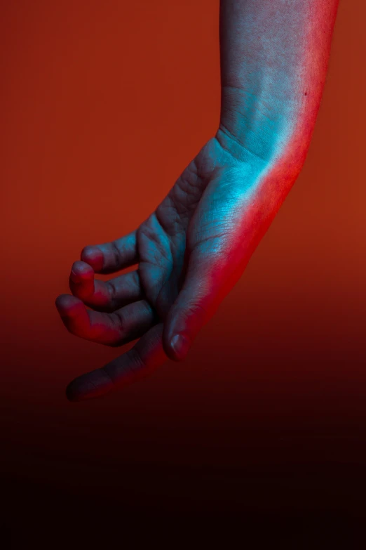 this is a picture of a person's hand holding soing red and blue