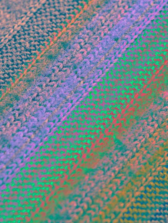 a close - up picture shows an iridescent image of blue, green and pink fabric