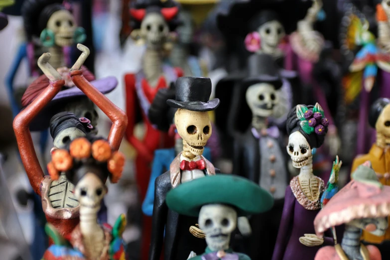 a group of halloween skeleton figurines with many different costumes