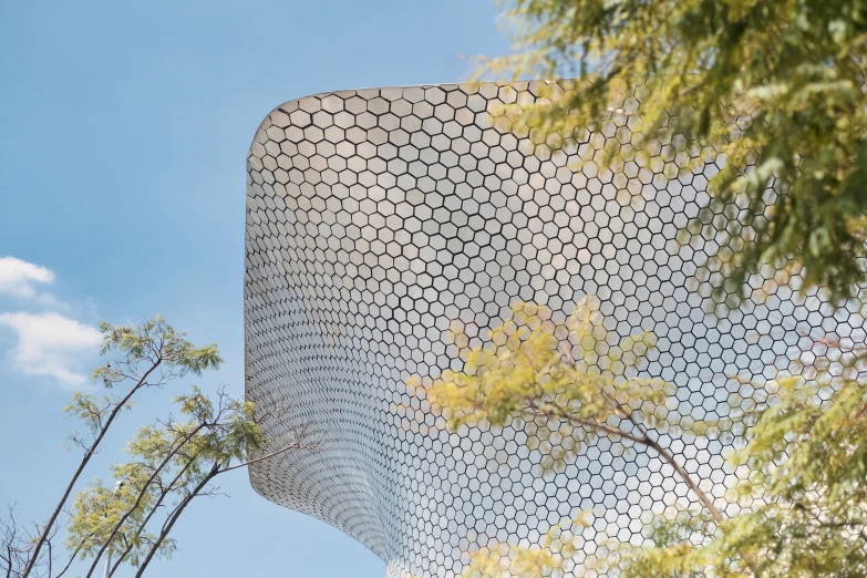 an unusual building with a decorative design on top