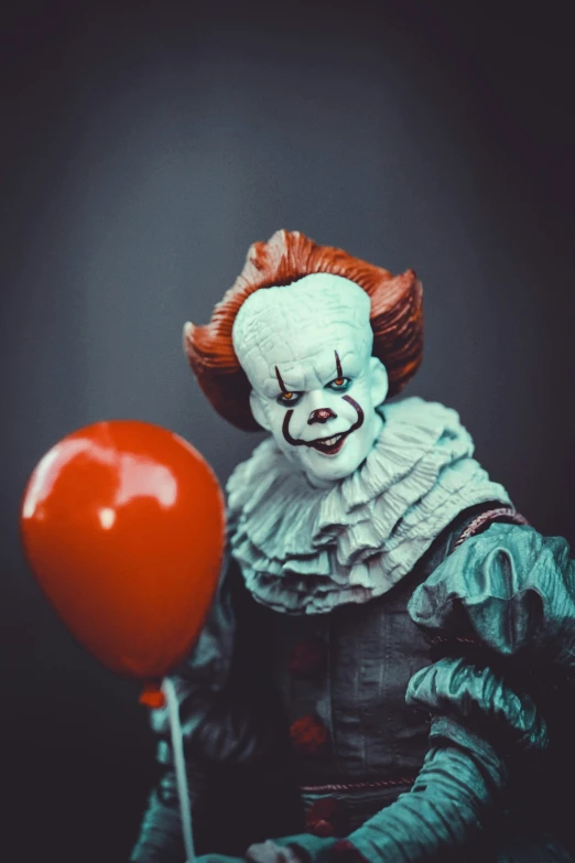 a creepy penny clown with a red balloon in the mouth