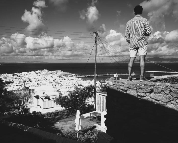 a man standing on top of a cement wall