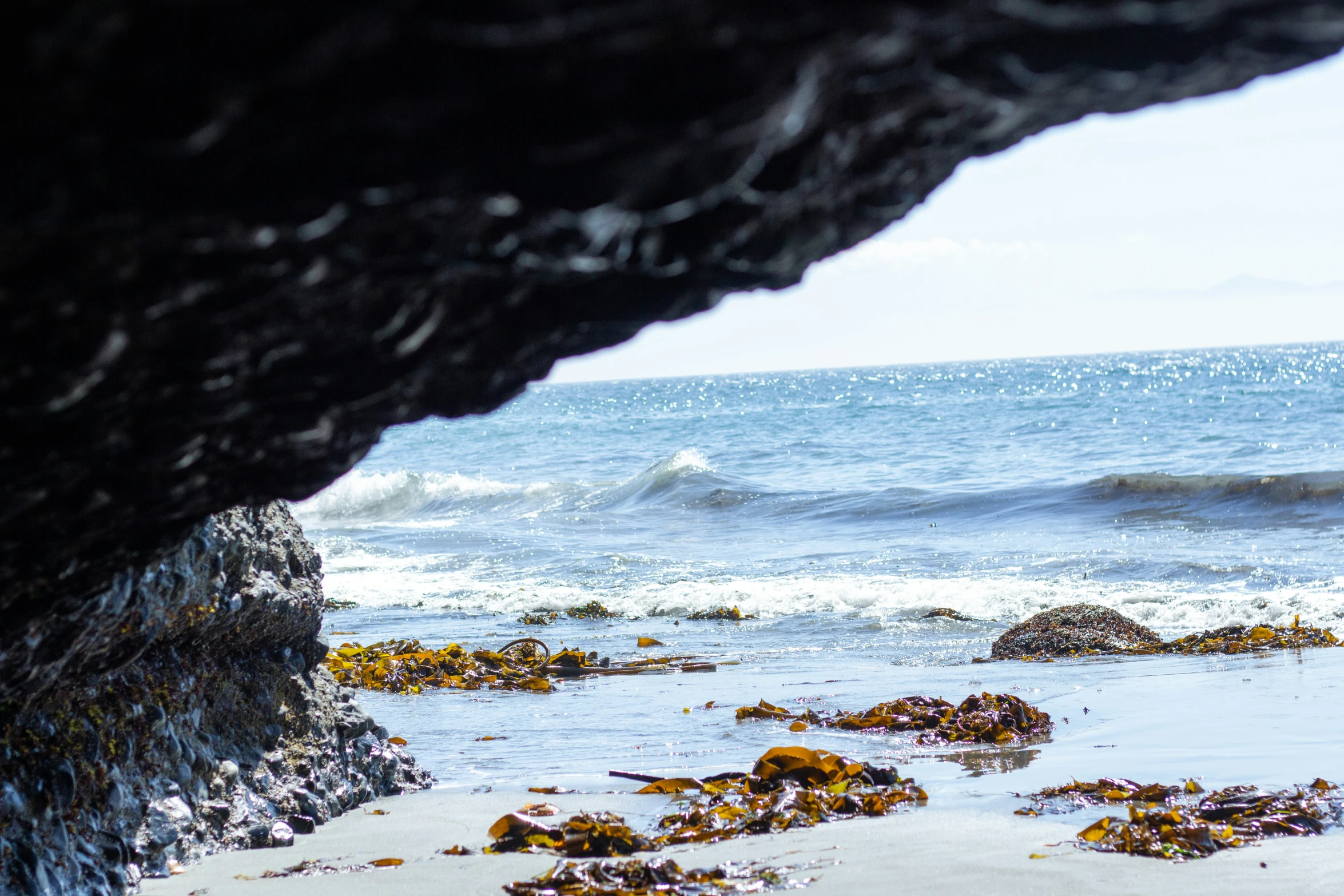 a rocky outcropping is near an ocean