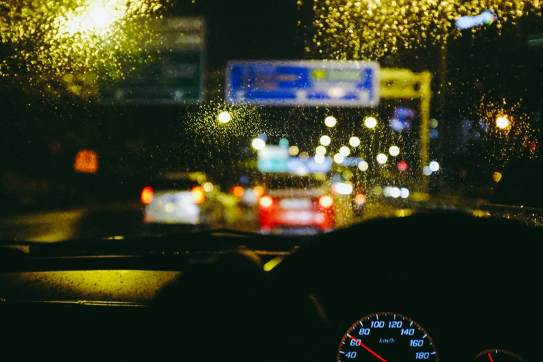 a rain is being blown on the windshield as cars drive past