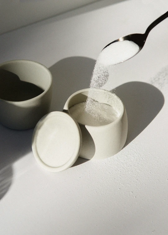 a spoon and bowls sitting next to each other on a table