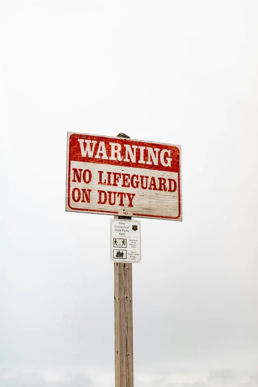 a warning sign stating that no lifeguard on duty is allowed