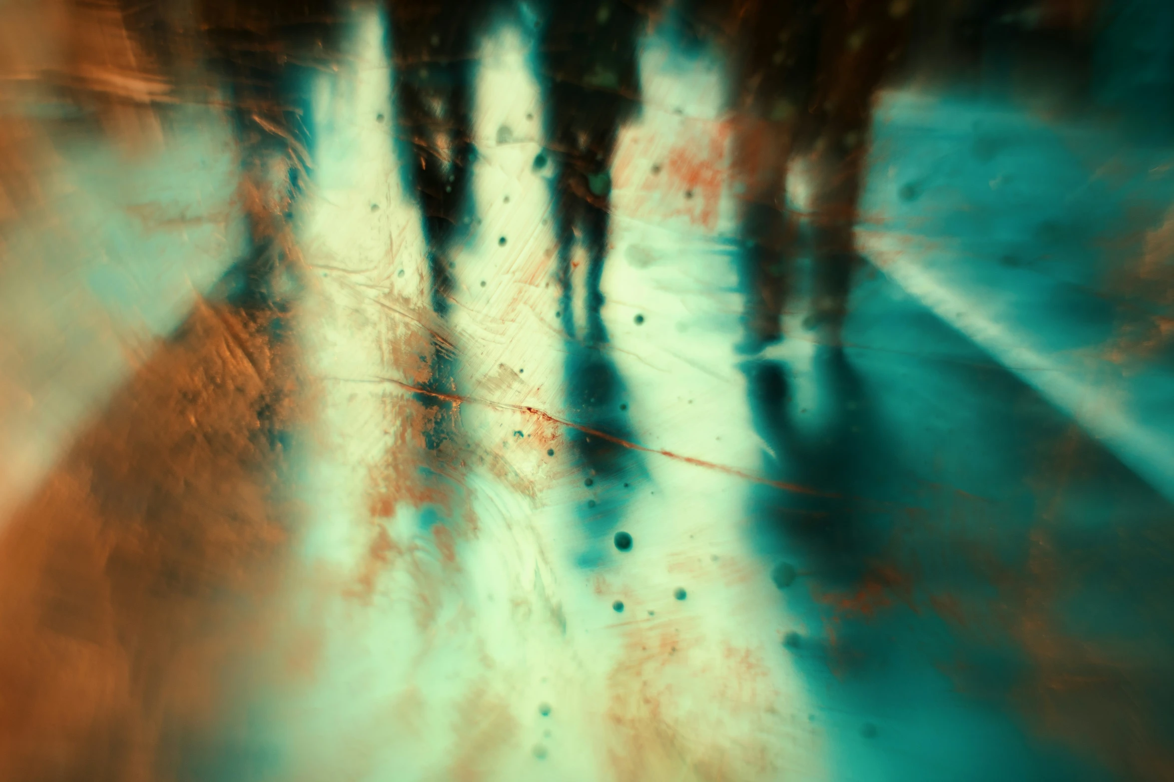 group of people walking across a wet surface