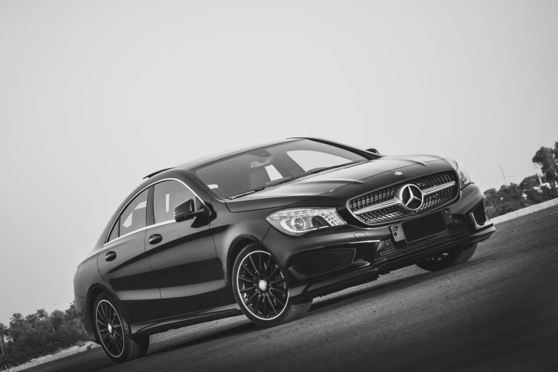 the black mercedes c - class driving down the road