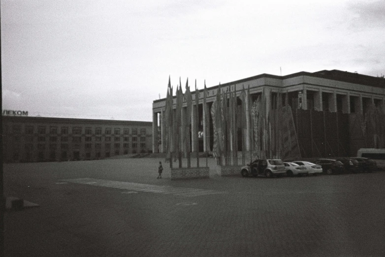 a car parked in front of a very tall building