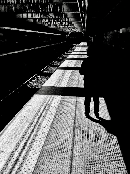 a black and white pograph of a man on a subway