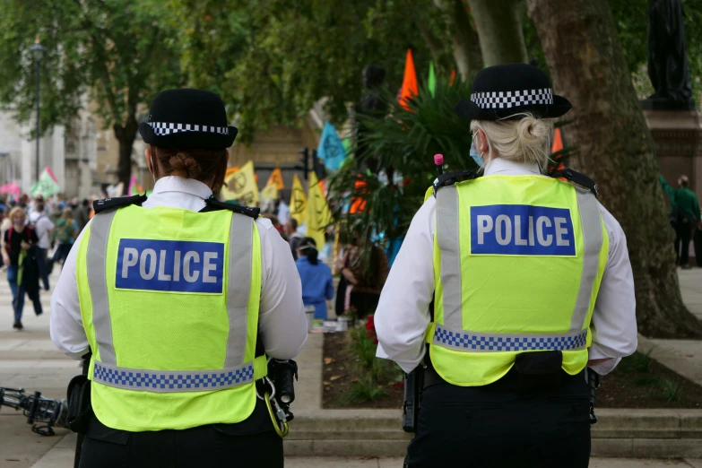 two police officers standing in front of a crowd