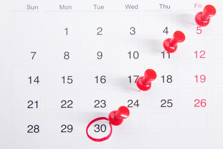 two red h pins in front of the calendar