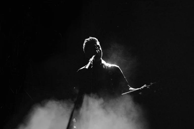 a black and white po of a man playing a guitar