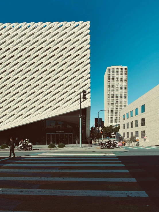 a large building with lots of windows next to another building