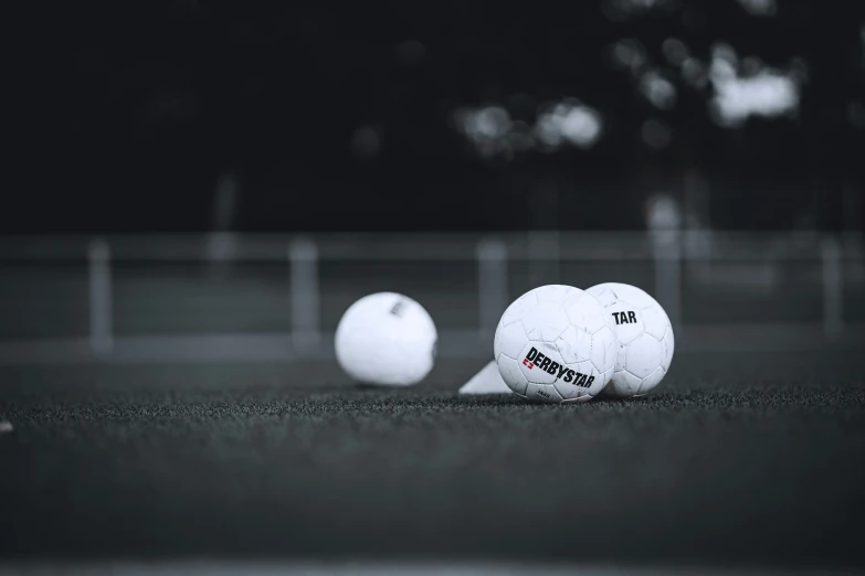 the three white balls are placed on the tennis court