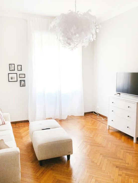 an open living room with wooden floors and a large window