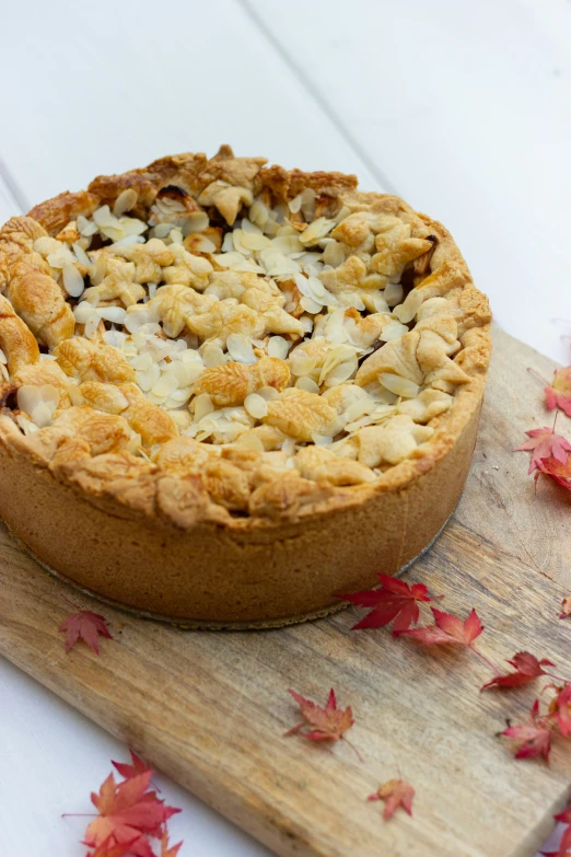 the pie has toppings on it and sitting on a wooden board