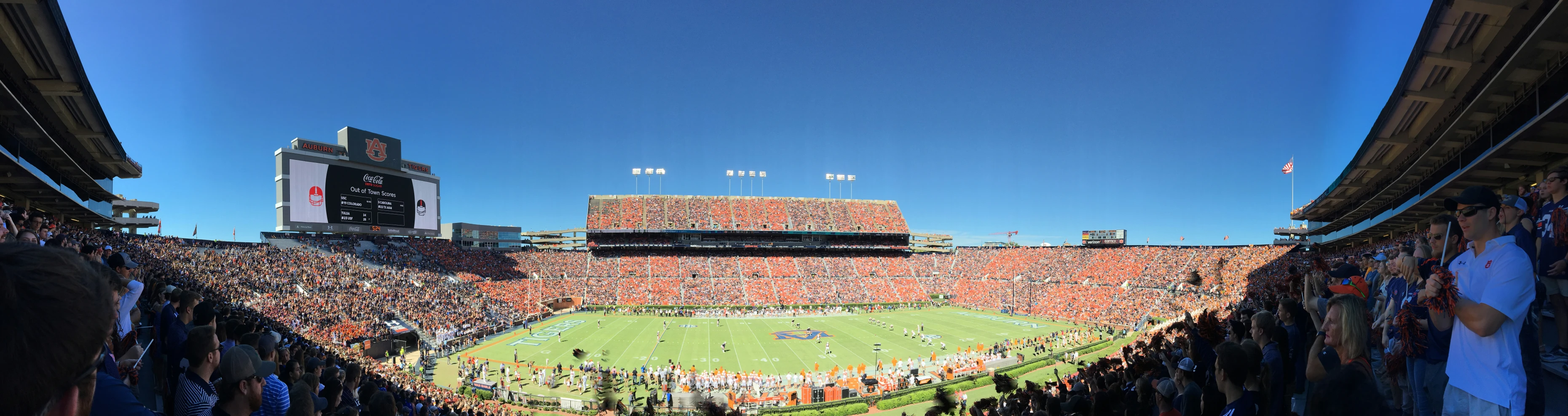 an stadium full of spectators watching a football game