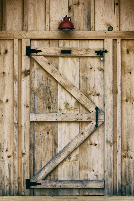 a rustic wood barn door has a brick chimney