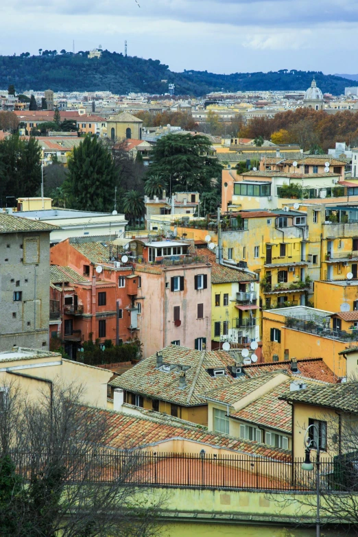 an overcast day in the distance as people stand on a city's roofs