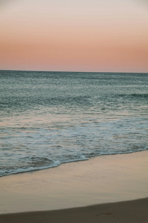 a large body of water sitting next to a sandy shore