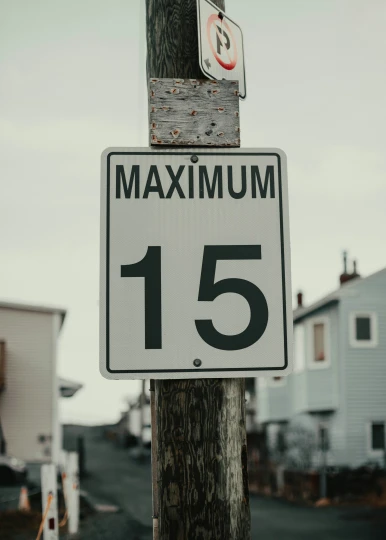 a wooden pole with a number 15 sign