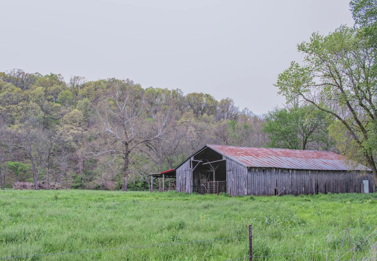 a barn in a field in the country