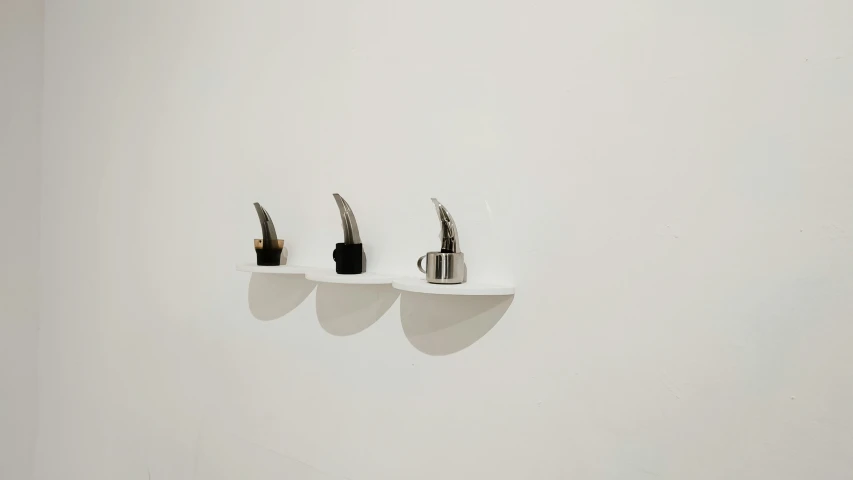 three small toothbrushes that are on shelves