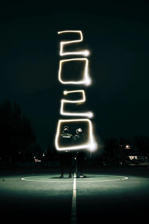 a large neon sign on a street at night