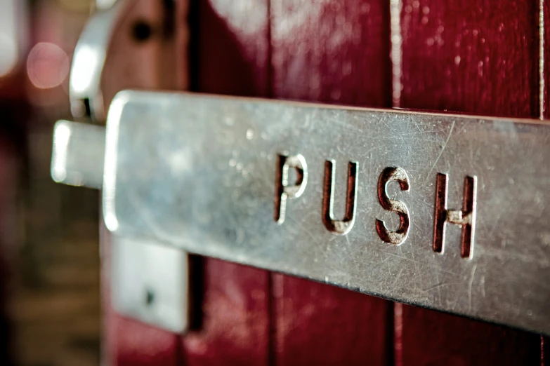 a close up of the word h on the door of a wooden cabin