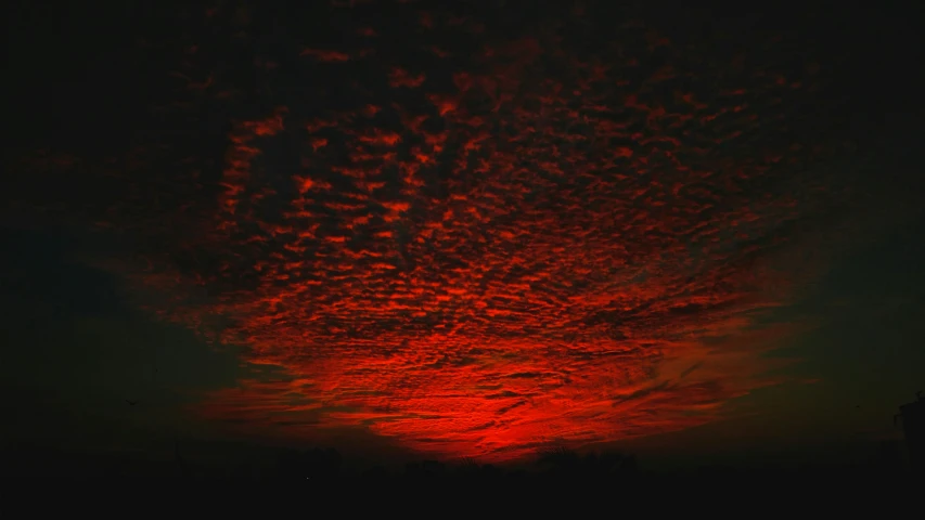 the sky is full of clouds at sunset