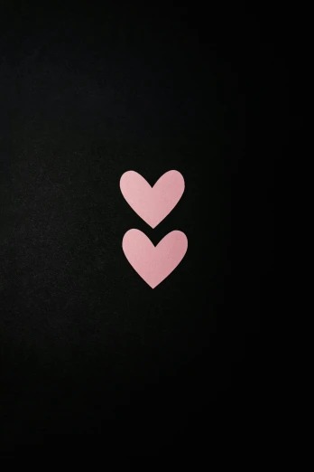 two pink hearts with one smaller one is in the center