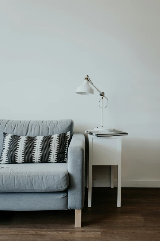 a blue couch with white accent pillows on it