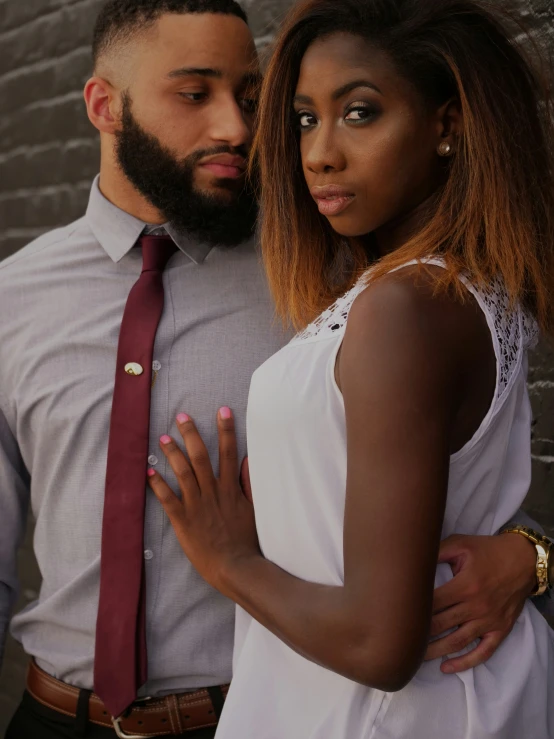 young couple dressed nicely and posing for po