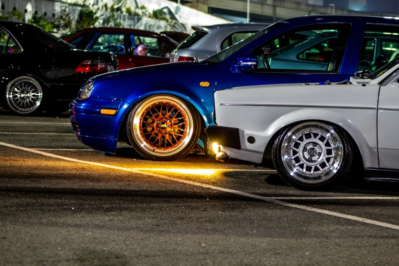 a couple of cars parked next to each other in a parking lot