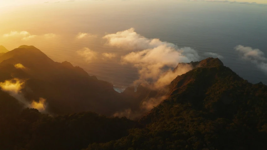 some mountains and clouds in the sky