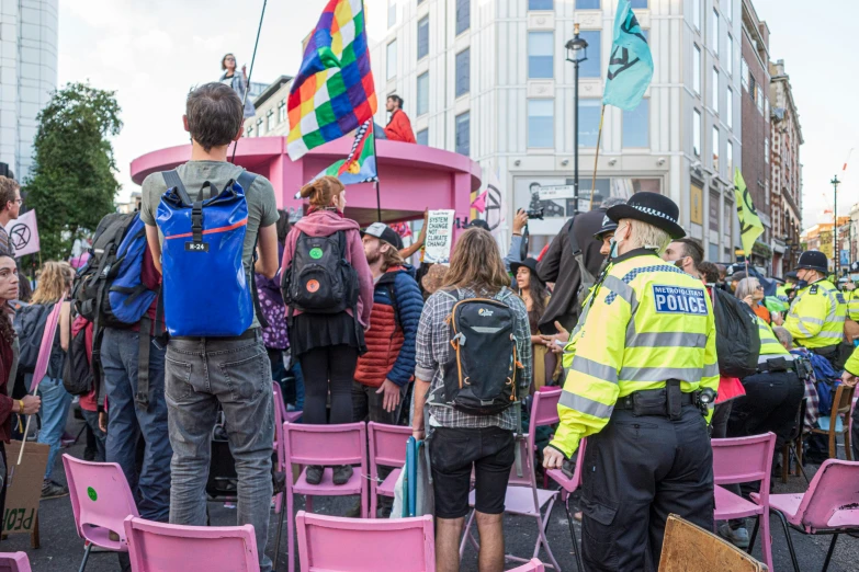 some police officers standing with a crowd and people