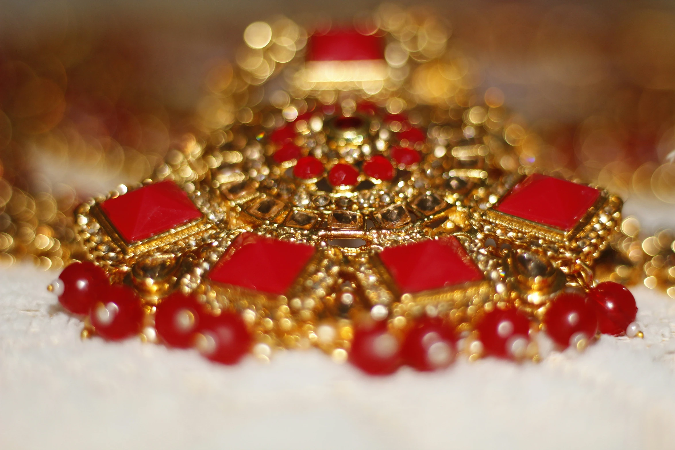 a jewelery is laying on the ground and gold beads around it